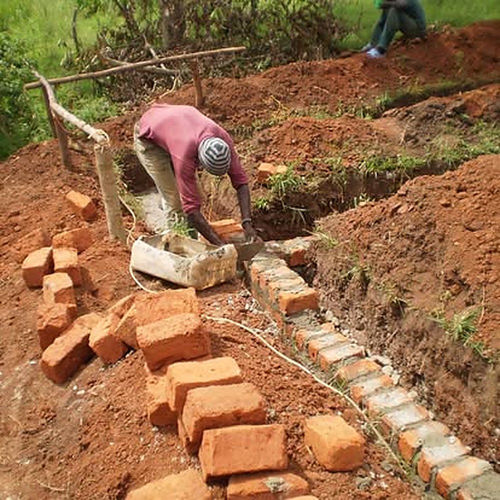 Laying bricks for a new classroom block