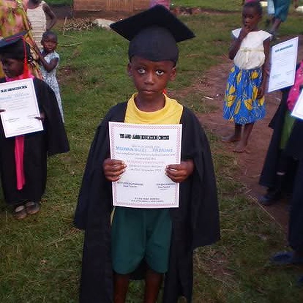 A proud graduate on nursery graduation day
