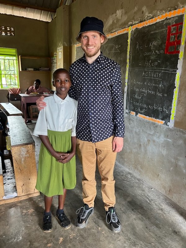 A YAEC pupil standing with a visiting supporter in her classroom