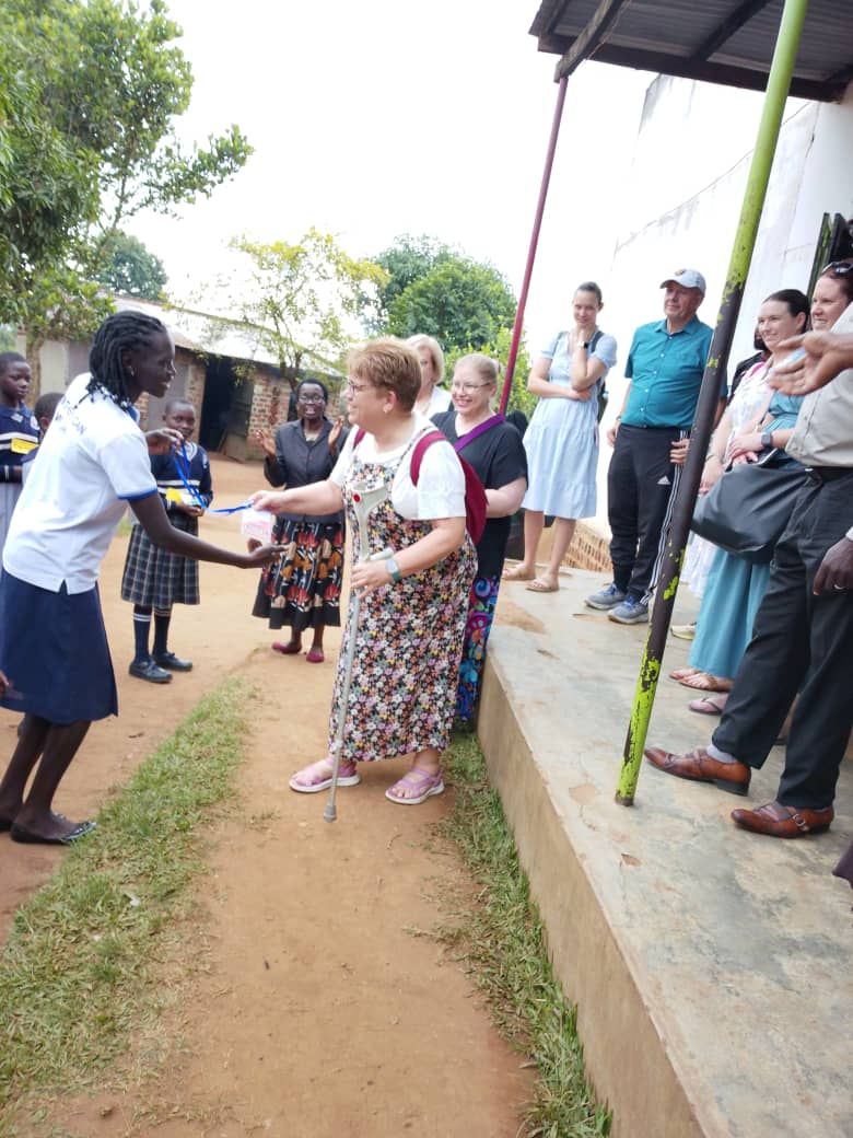 A pupil welcomes a volunteer with a name badge